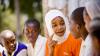 A female student shares a light moment with her colleagues during break time
