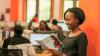 A woman reading a British Council brochure in an office.